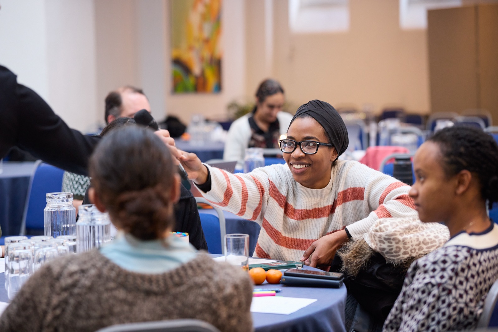 Participants laughing together at tables during an AI innovation day