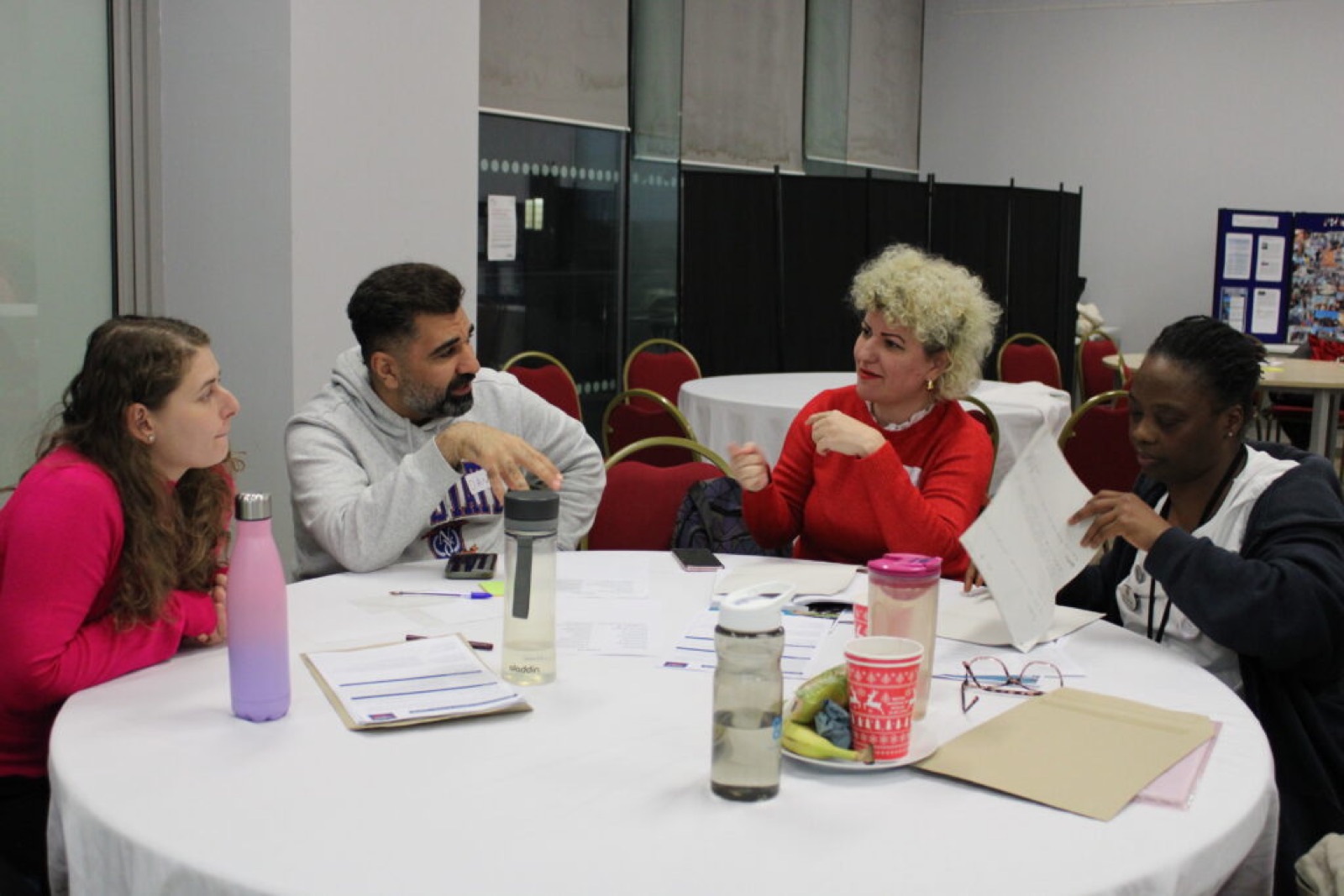 People in discussion around a round table in Barking and Dagenham